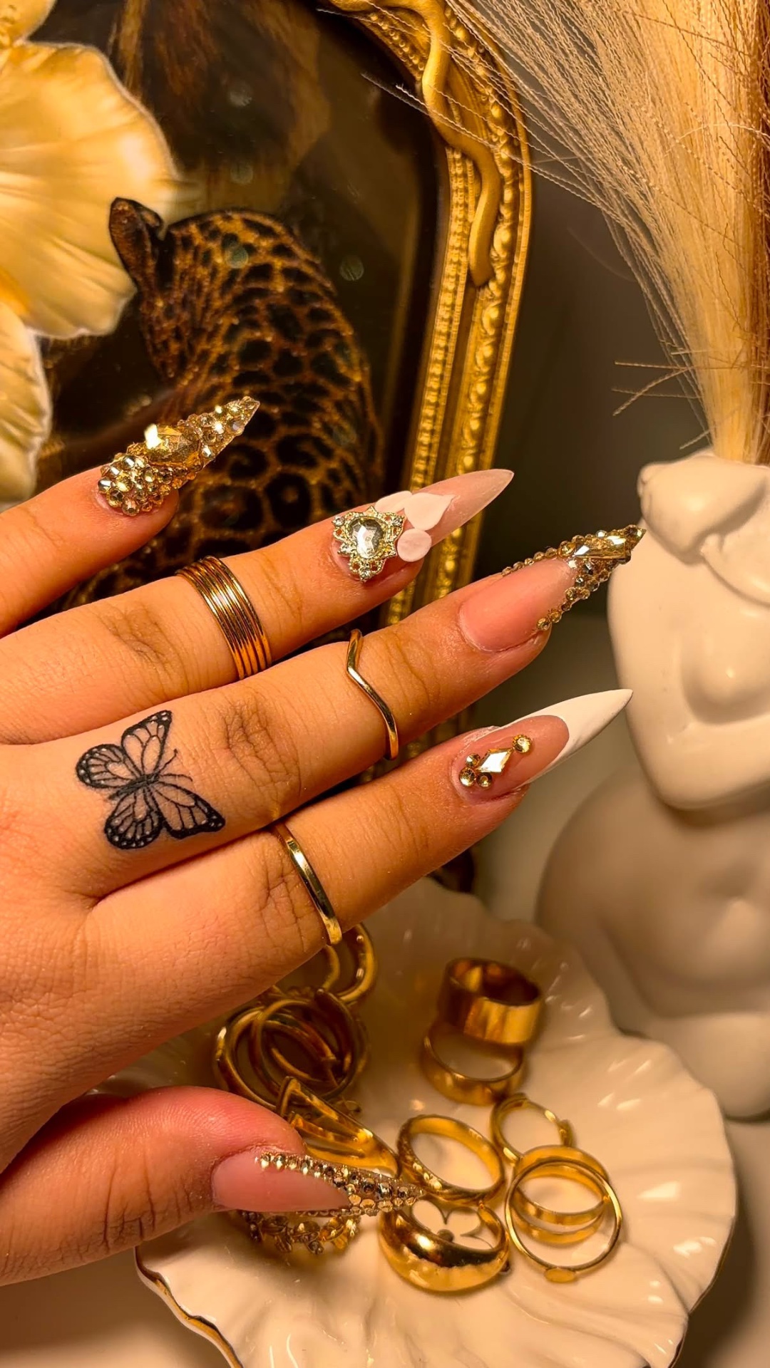 Long gold rhinestone stiletto Gel-X set with white accent nail