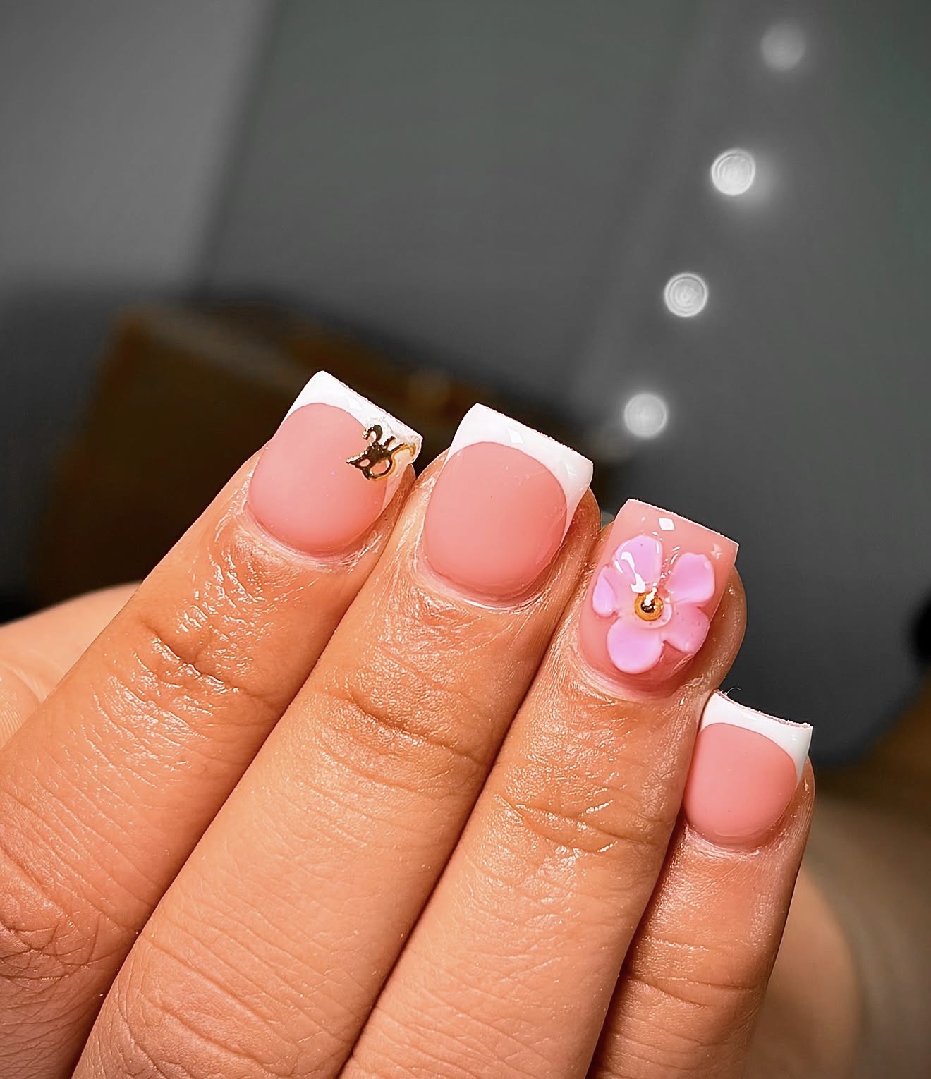 Short nude pink Gel-X French set with gold cat charm and 3D pink flower